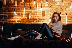 Cute girl sitting on the couch. photo