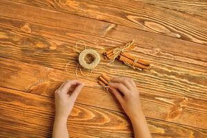 Cinnamon sticks and twine on a wooden background. photo