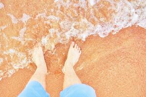 Men's feet on the beach. photo