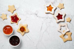 Traditional Linzer cookies with red and yellow jam. Cooking Christmas background photo