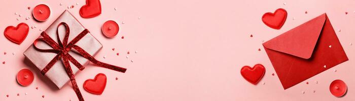 Valentines day banner. Red envelopewith, Gift box and hearts on pink background. Romantic concept photo