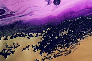 Fluid Art. Metallic gold abstraction and black purple waves. Marble effect background or texture photo