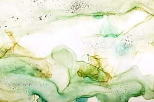 Watercolor alcohol ink swirls. Transparent waves and swirls in green colors. Delicate pastel spots and grains photo