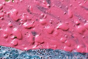 Fluid Art. Bubble paint abstraction. Tactile bumpy pink paint background or texture close-up photo