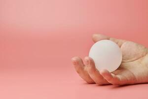 Crystal ball in hand, copy space. Magic solution or new idea concept. Creative minimal innovations. photo