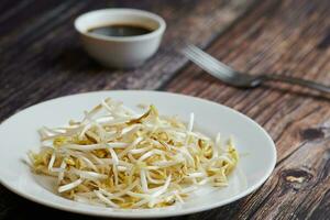 Mung bean sprouts in plate. Raw organic healthy food. Traditional vegetable dish in east Asia. photo