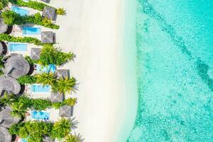 Sea beach aerial. Luxury summer travel vacation landscape. Tropical beach, drone view. Beach villas bungalows of hotel resort. Perfect beach scene vacation, summer holiday template. Wonderful nature photo
