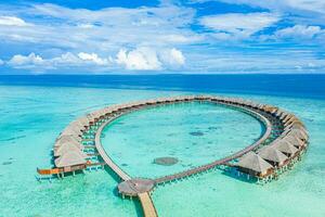 Maldives paradise scenery. Tropical aerial landscape, seascape, water villas with amazing sea and lagoon beach, tropical nature. Exotic tourism destination banner, summer aerial vacation, drone view photo