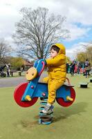 Cute Asian Pakistani Baby Ahmed Mustafain Haider is Enjoying The Beautiful Sunny Day at Wardown Public Park of Luton Town of England UK. Image Was Captured on 03-April-2023 photo