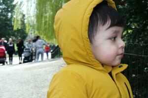 Cute Asian Pakistani Baby Ahmed Mustafain Haider is Enjoying The Beautiful Sunny Day at Wardown Public Park of Luton Town of England UK. Image Was Captured on 03-April-2023 photo