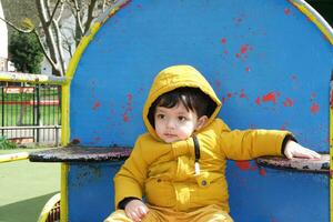 Cute Asian Pakistani Baby Ahmed Mustafain Haider is Enjoying The Beautiful Sunny Day at Wardown Public Park of Luton Town of England UK. Image Was Captured on 03-April-2023 photo