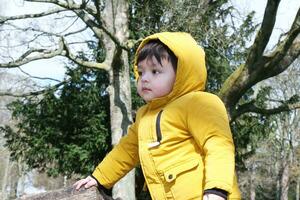 Cute Asian Pakistani Baby Ahmed Mustafain Haider is Enjoying The Beautiful Sunny Day at Wardown Public Park of Luton Town of England UK. Image Was Captured on 03-April-2023 photo