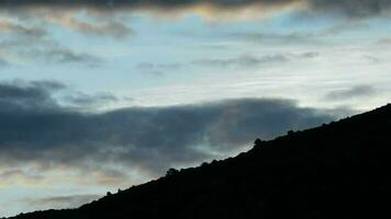 Clouds passing at timelapse in the mountain at sunrise video