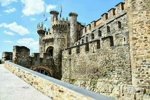 the castle is made of stone and has a stone wall photo