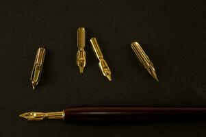 a gold fountain pen with a gold nib and a gold cap photo