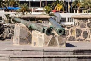 two cannons on a stone pedestal in front of a building photo