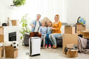 air purifier in living room with happy family moving to new apartment photo