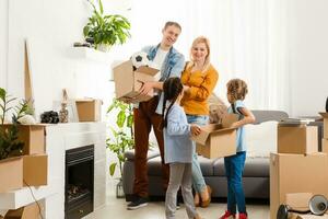 Happy family with cardboard boxes in new house at moving day. photo