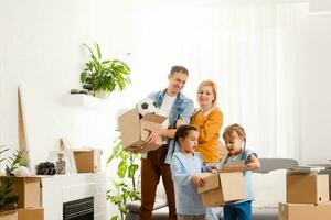 Happy family moving home with boxes around photo