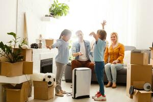 air purifier in living room with happy family moving to new apartment photo