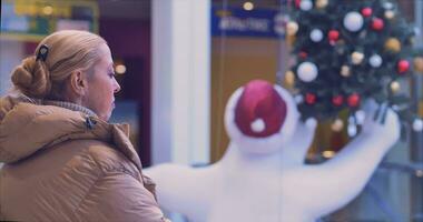 ein Mädchen im ein Neu Jahre groß Einkaufen Center. Weihnachten Baum, Spielzeuge auf das Weihnachten Baum video