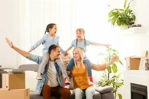 Happy family moving home with boxes around photo