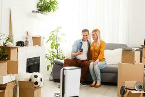 family with an air purifier moving to a new apartment photo