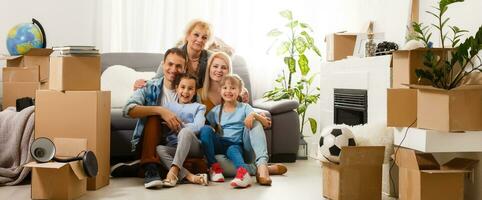 Portrait of nice attractive lovely charming cheerful big full family sitting mom dad making roof new apartment move photo