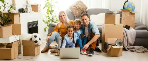 Portrait of nice attractive lovely charming cheerful big full family sitting mom dad making roof new apartment move photo