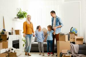 Family with cardboard boxes standing in row at home photo
