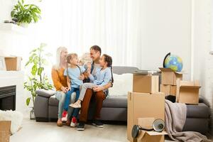 Happy family with cardboard boxes in new house at moving day. photo