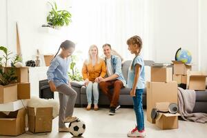 Happy family moving home with boxes around photo