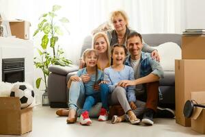 big family moving into a new apartment. Room with empty walls, new beginning. photo