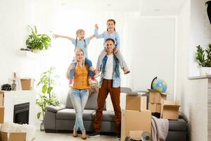 Happy family with cardboard boxes in new house at moving day. photo