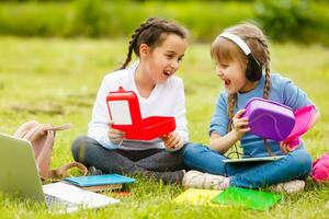 kids on the picnic in school grass yard are coming eat lunch in box. parent take care of childcare. photo