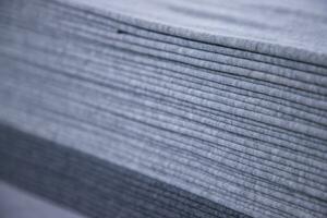 Stacked folded  Gray fabric Surface Texture Background Wallpaper. Selective Focus photo