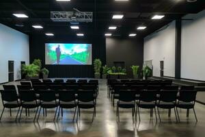 AI generated Conference room with empty chairs and TV screen in the conference hall, A modern training hall with chairs facing a giant stage with one big screen displaying, AI Generated photo