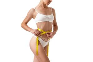 Female body with the drawing arrows on it isolated on white. Fat lose, liposuction and cellulite removal concept. photo