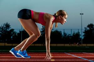 Portrait of beautiful woman ready to start running. photo