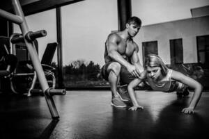 Sportive woman doing plank exercise training back and press musc photo