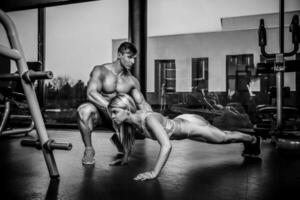 Sportive woman doing plank exercise training back and press musc photo