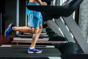 Legs running on the treadmill close up photo