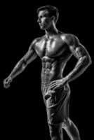 Muscular and fit young bodybuilder fitness male model posing ove photo