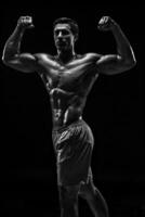 Muscular and fit young bodybuilder fitness male model posing ove photo