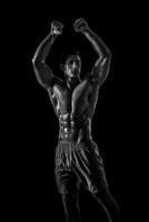 Muscular and fit young bodybuilder fitness male model posing ove photo