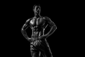 Muscular and fit young bodybuilder fitness male model posing ove photo