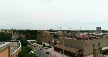 A drone descends and rises over the ancient gates of the MagokiAttari Mosque complex in old Bukhara, Uzbekistan. Cloudy day. video