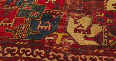 Macro shot of an old shabby handmade carpet made by Samarkand masters using ancient technology. It is covered with national patterns and ornaments. Uzbekistan. video