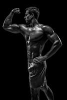 Muscular and fit young bodybuilder fitness male model posing ove photo