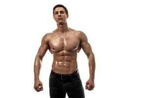 Muscular handsome young man with naked torso. Isolated on white background. Copy space photo